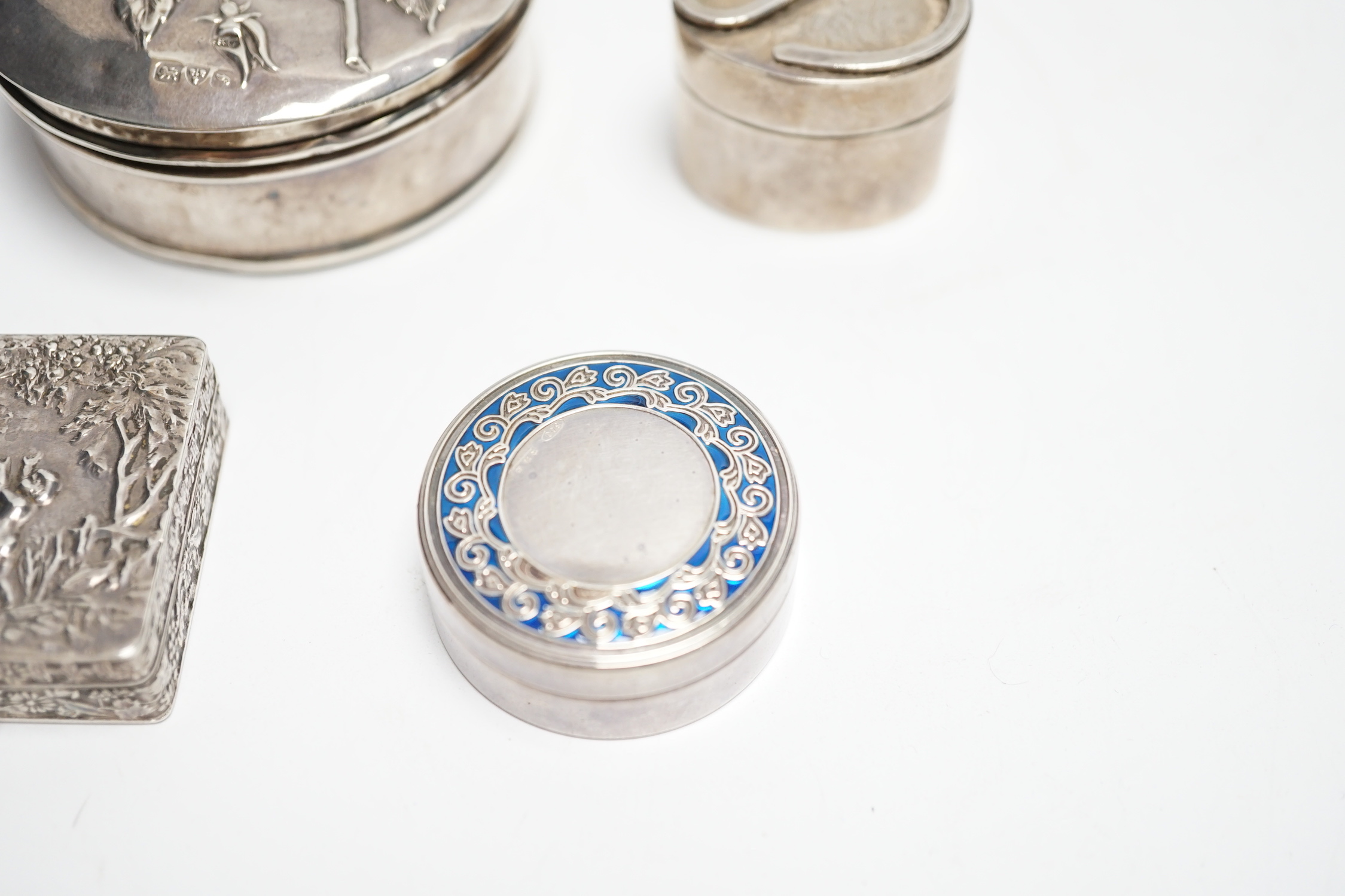 An Edwardian silver circular trinket box, embossed with a rose, Chester, 1909, 65mm, two modern pill boxes, silver and 800 standard with enamel and a modern Italian silver pill box.